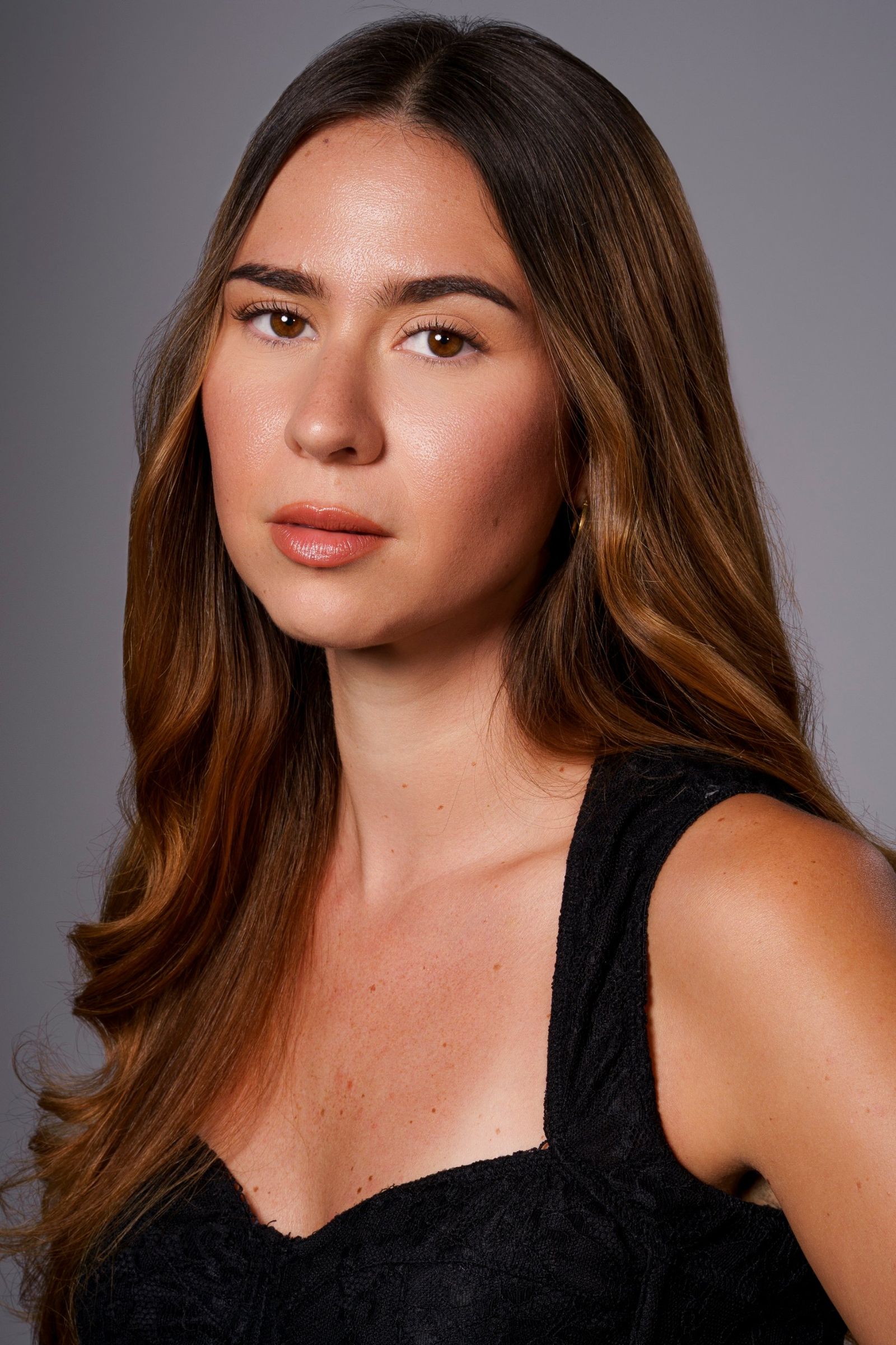 Alesia Rieser, headshot in black lace, looking directly into camera